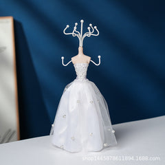 Elegant white stand holding various jewellery pieces