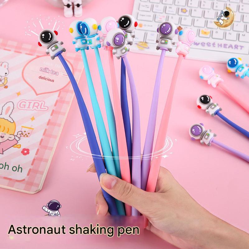 Set of astronaut-themed gel pens on a white background