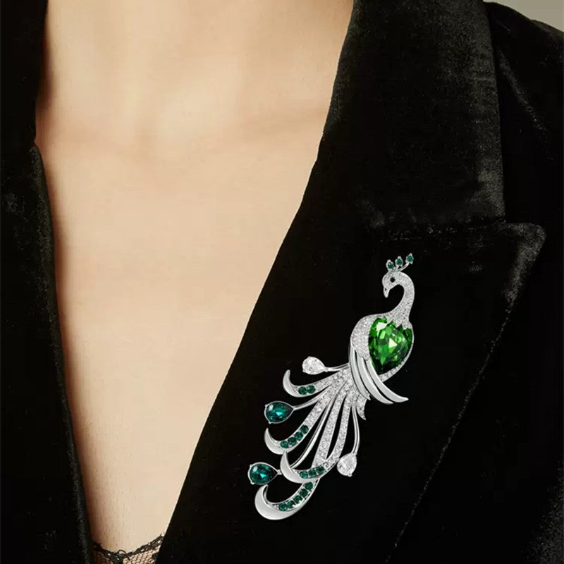 Elegant green zircon peacock brooch on display