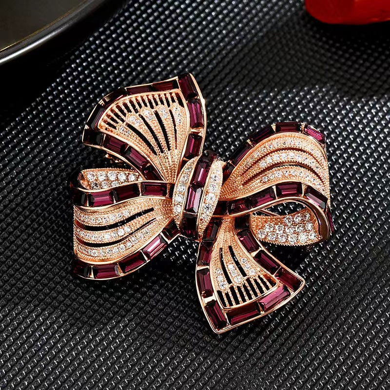 Gold Butterfly Knot Brooch styled on a sweater