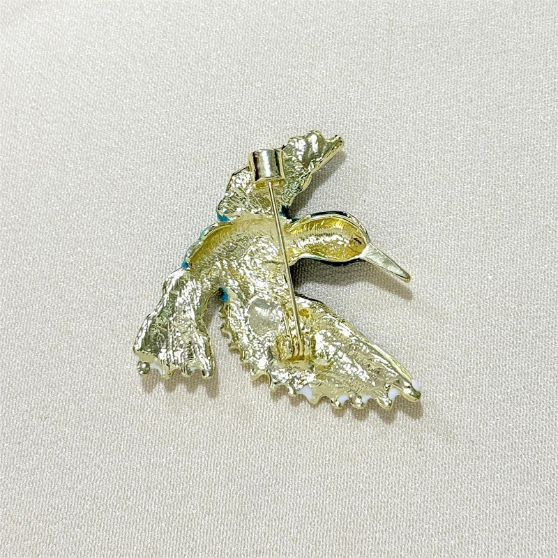 Close-up of blue wing bird detail on brooch