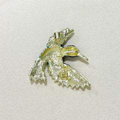 Close-up of blue wing bird detail on brooch