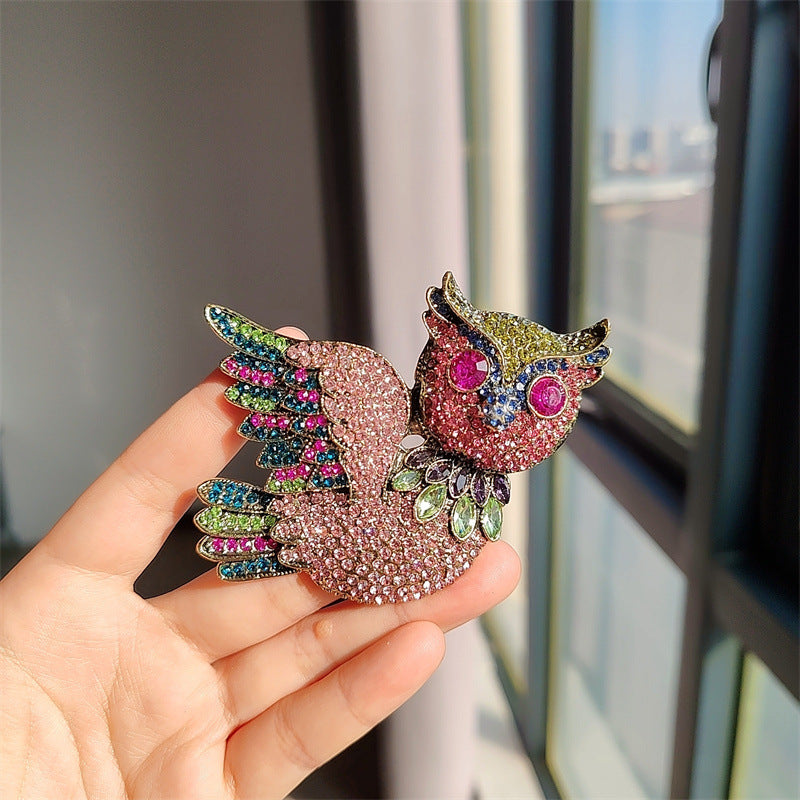 owl brooch displayed on a stylish outfit
