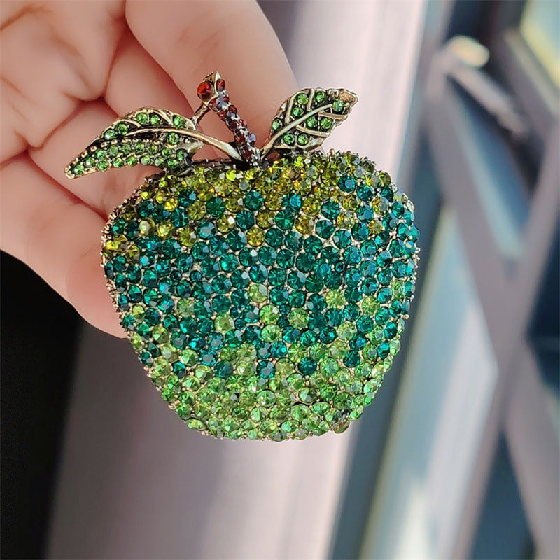Rhinestone adorned apple and avocado brooch detail