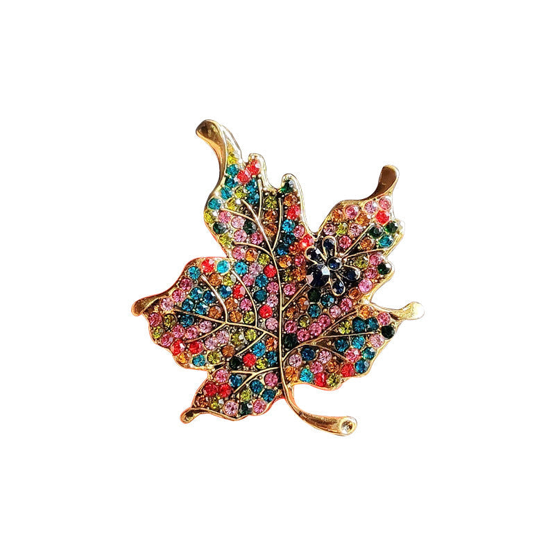 Leaf pin accessory styled with a jacket