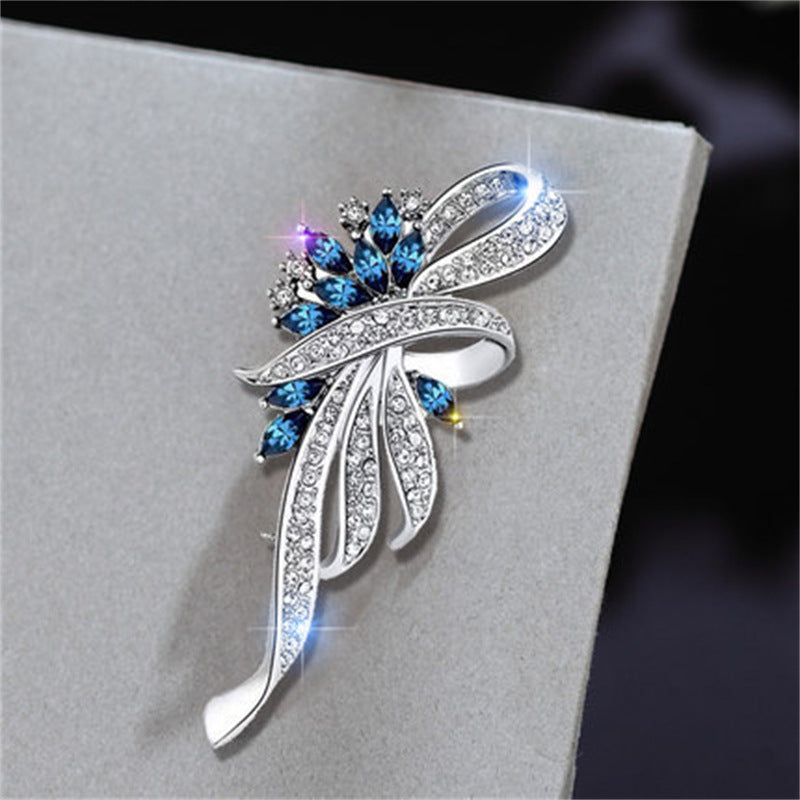 Close-up of blue gemstone floral brooch