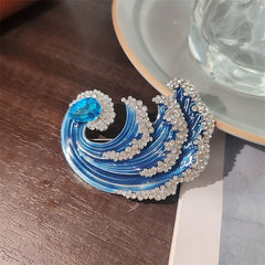 Close up of wave brooch detailing