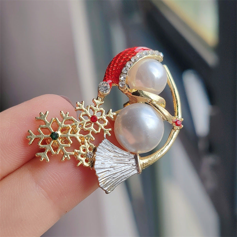 Snowman brooch displayed on sweater