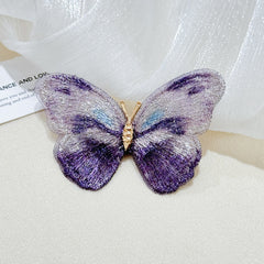 Close-up of floral brooch with butterfly design