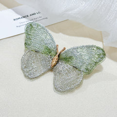 Side view of colourful butterfly brooch