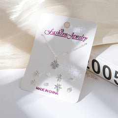 Gold alloy earrings alongside the matching necklace