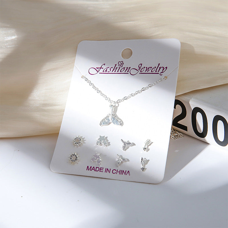 Close-up of gold crystal earrings with snowman design
