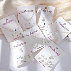 Close-up of gold crystal earrings with snowman design