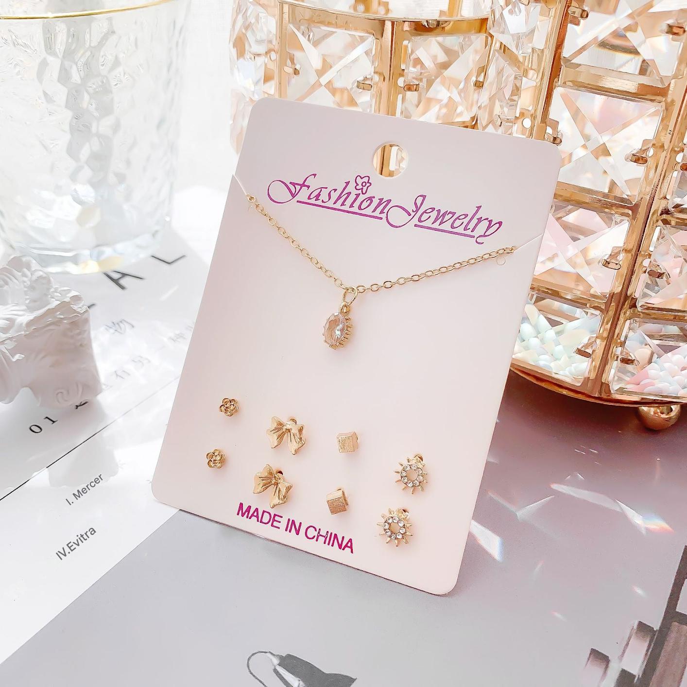 Gold alloy earrings alongside the matching necklace