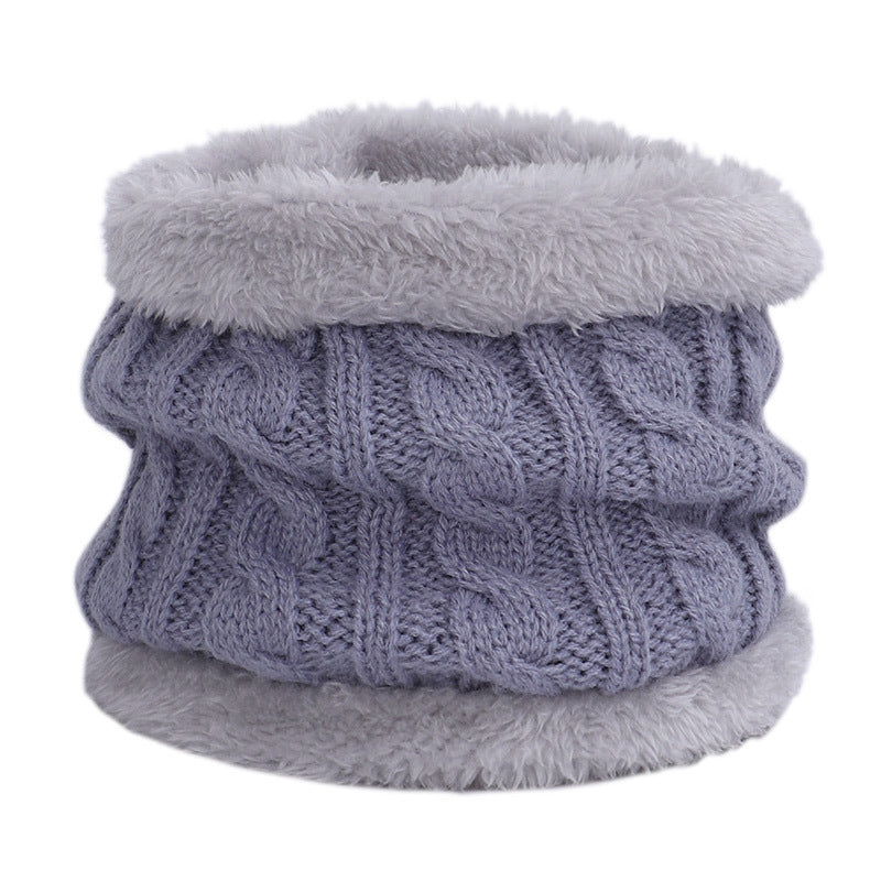 Knit hat and scarf set laid out on a snowy background