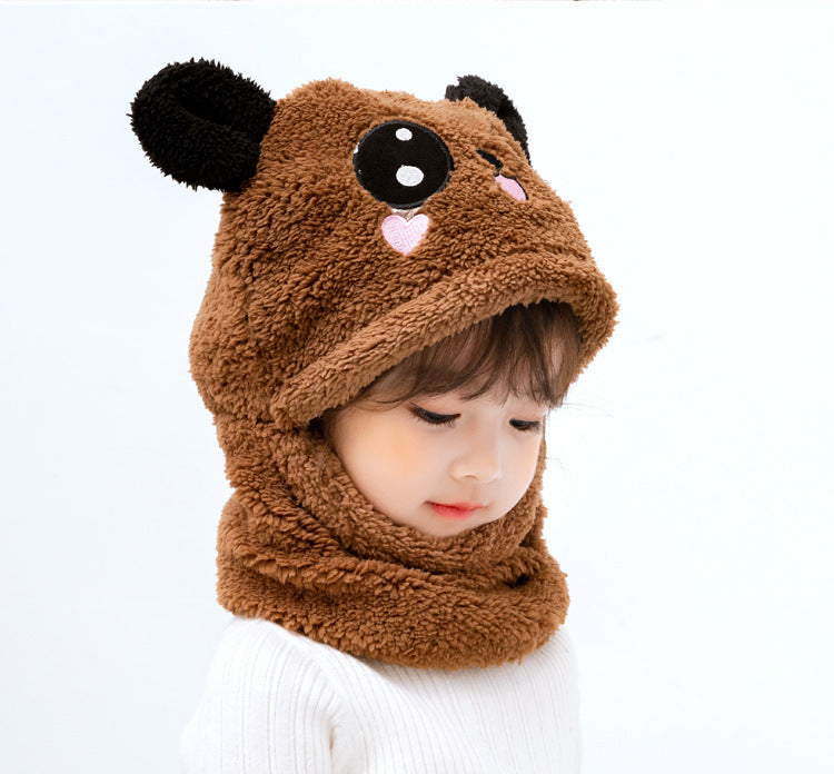 Little girl wearing colourful winter hat and scarf