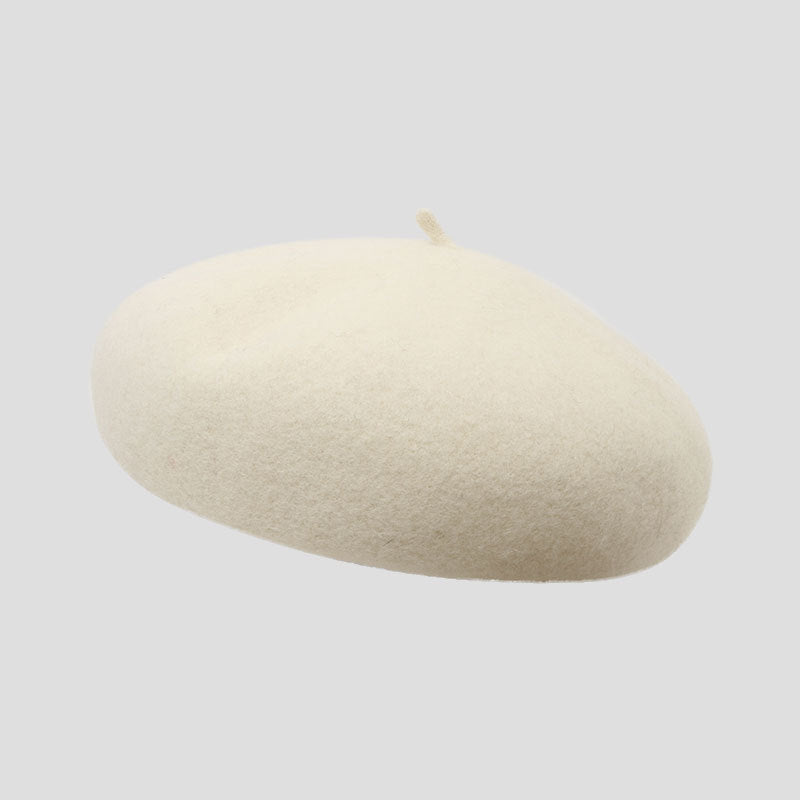 Chic brick red wool beret on display