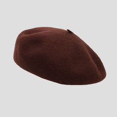 Chic brick red wool beret on display
