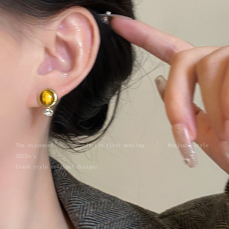 Round vintage tiger eye earrings on a white background