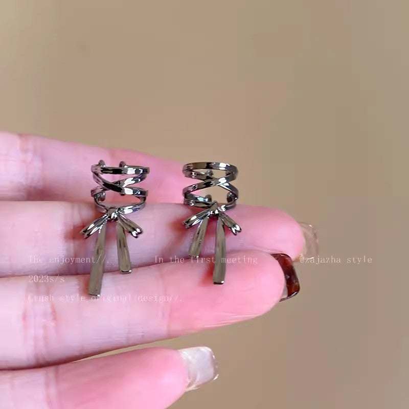 Stylish ear cuffs displayed in light setting
