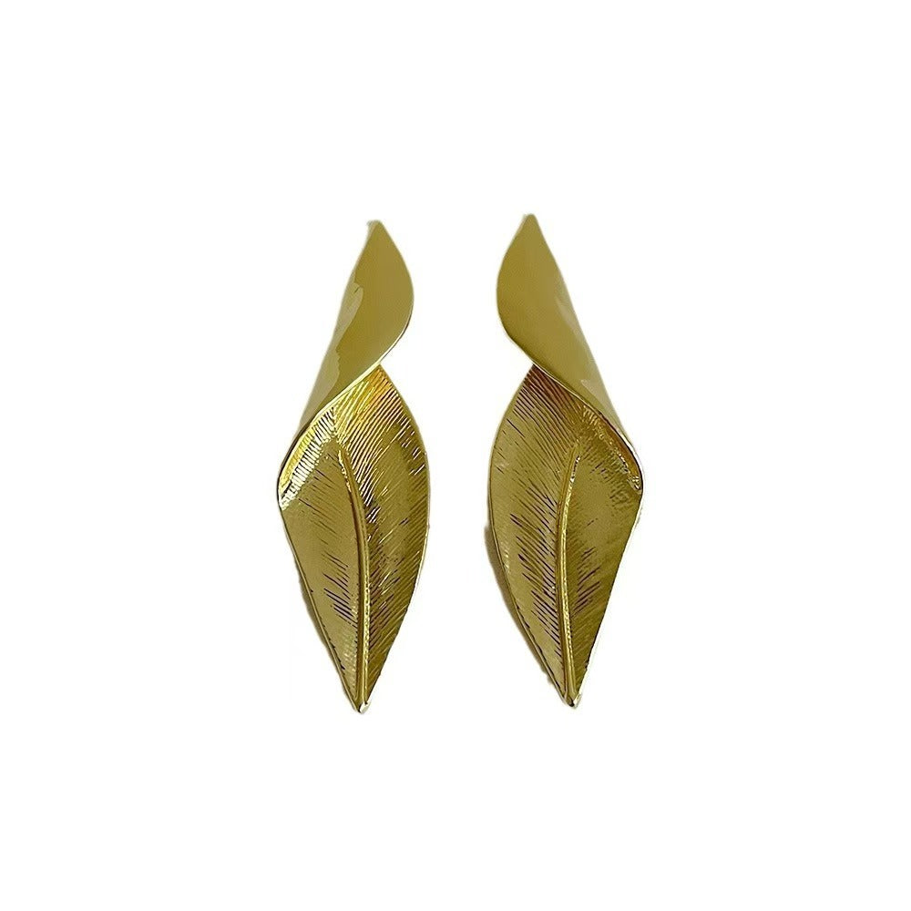 Stylish woman wearing vintage leaflet earrings outdoors