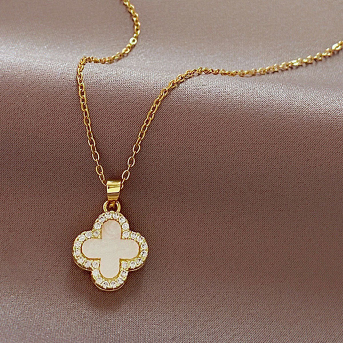 Stylish four-leaf clover necklace shown on a model