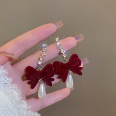 Stylish women's velvet bow earrings on model