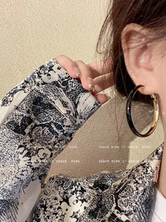 Fashionable earrings displayed on fashion magazine