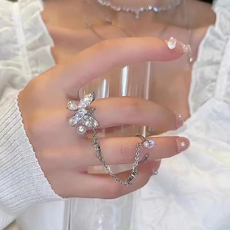 Close-up of butterfly pearl necklace with tassels