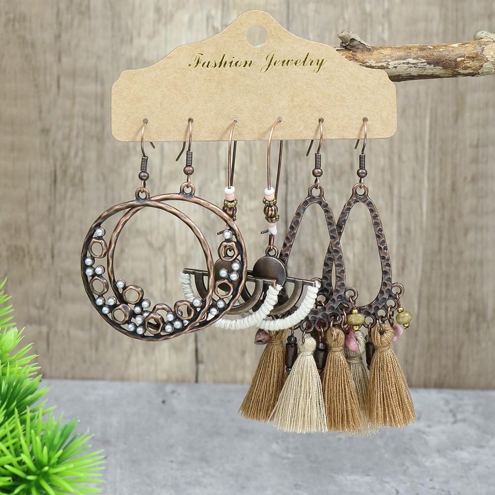 close-up of geometric design long tassel earrings
