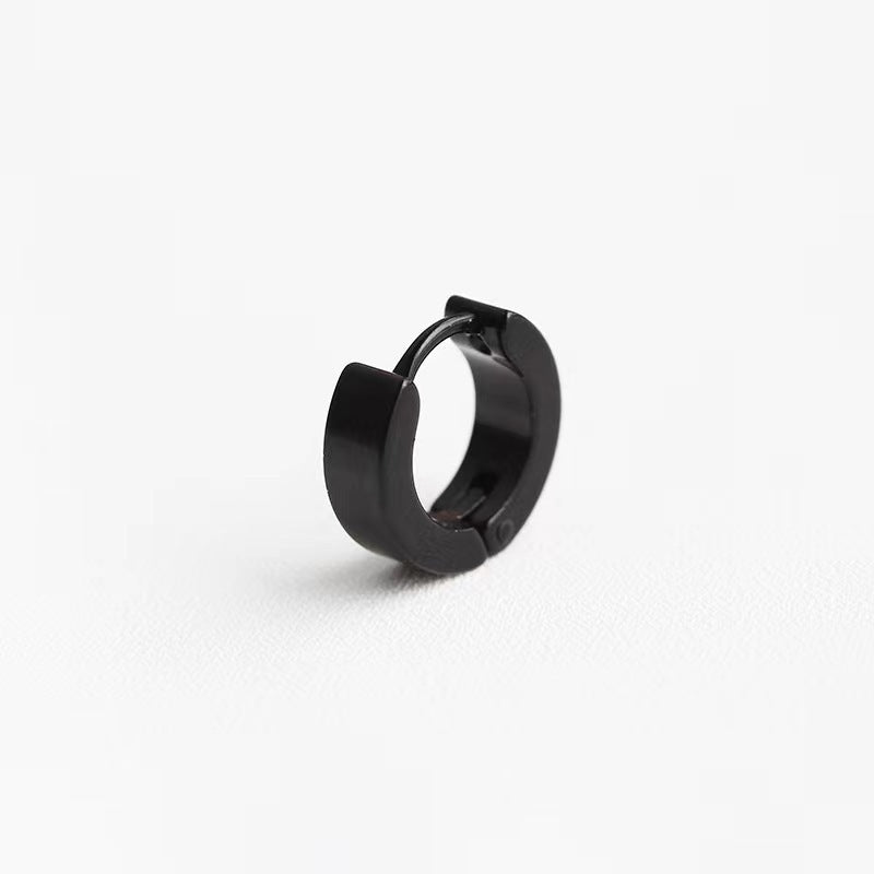 Black geometric titanium earrings on display