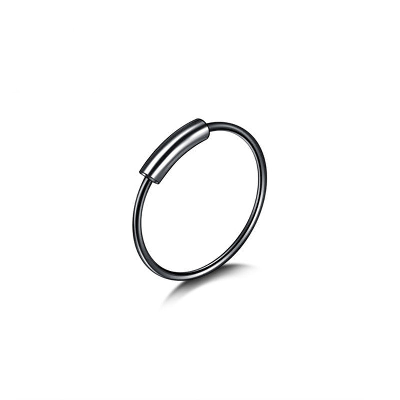 Close-up view of stylish nose ring and earrings set in stainless steel