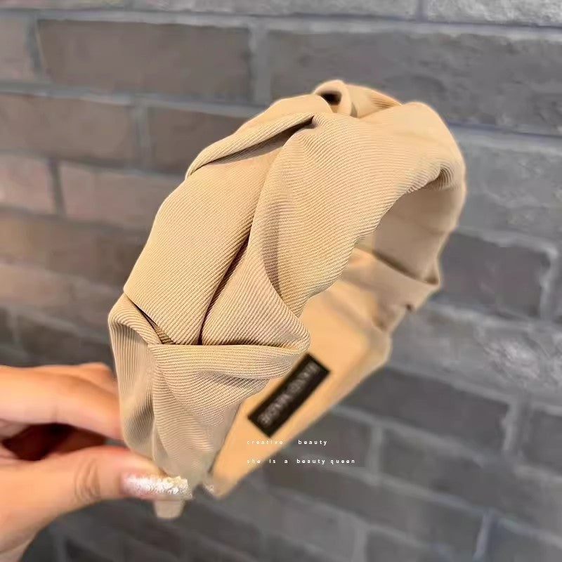 Stylish wide hairband in use during skincare