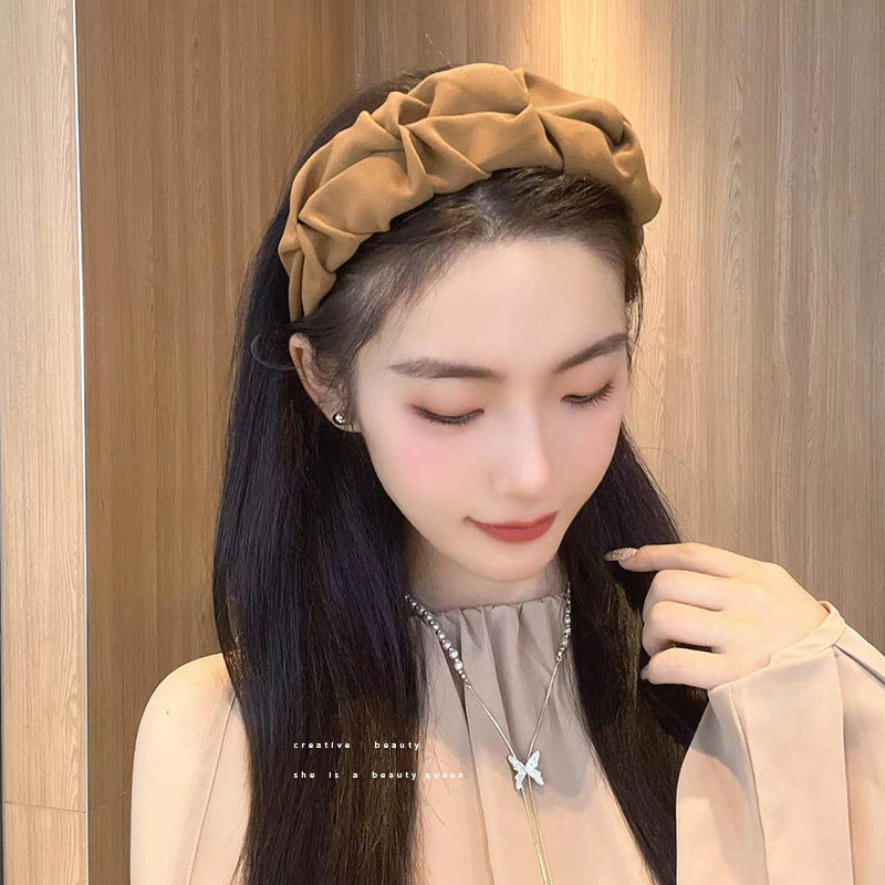 Stylish wide hairband in use during skincare