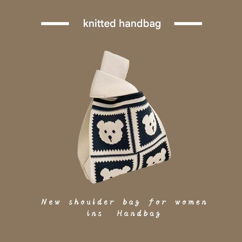 Women using a knitted tote bag outdoors