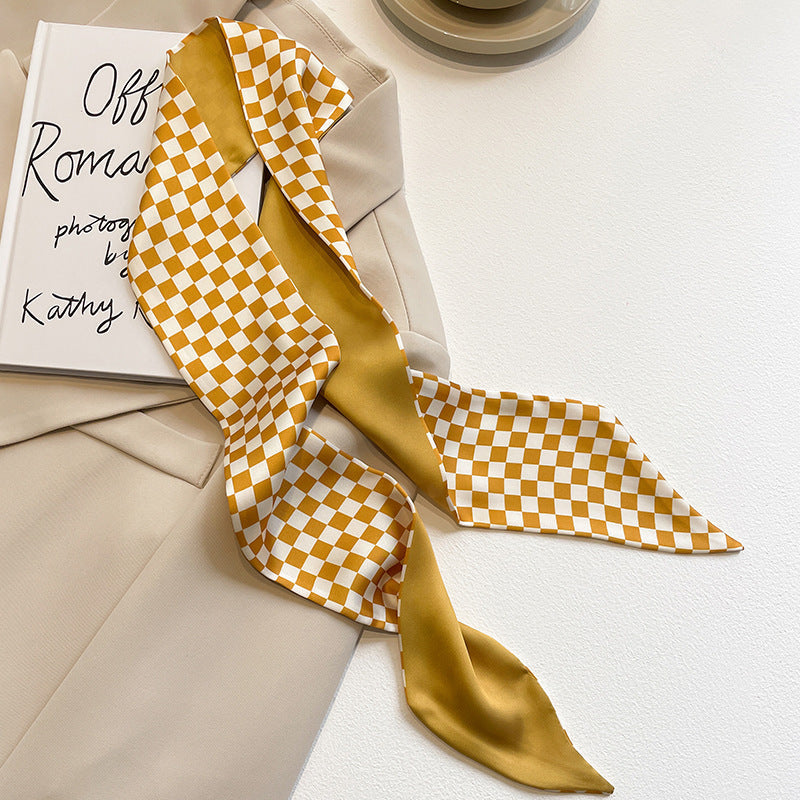flat lay of yellow floral scarf on white background