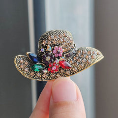 Elegant rhinestone brooch displayed on fabric